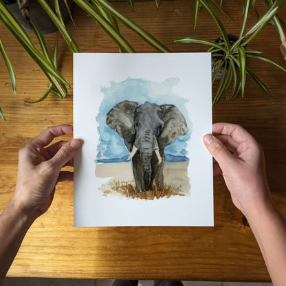 a person holding a card with a picture of an elephant