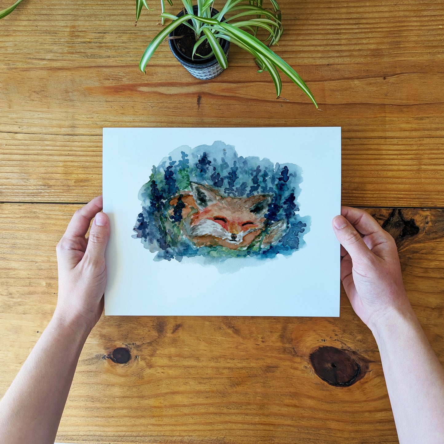 a person holding a card with a picture of a fox