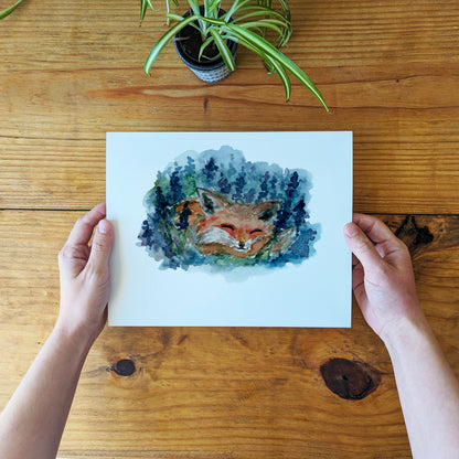 a person holding a card with a picture of a fox