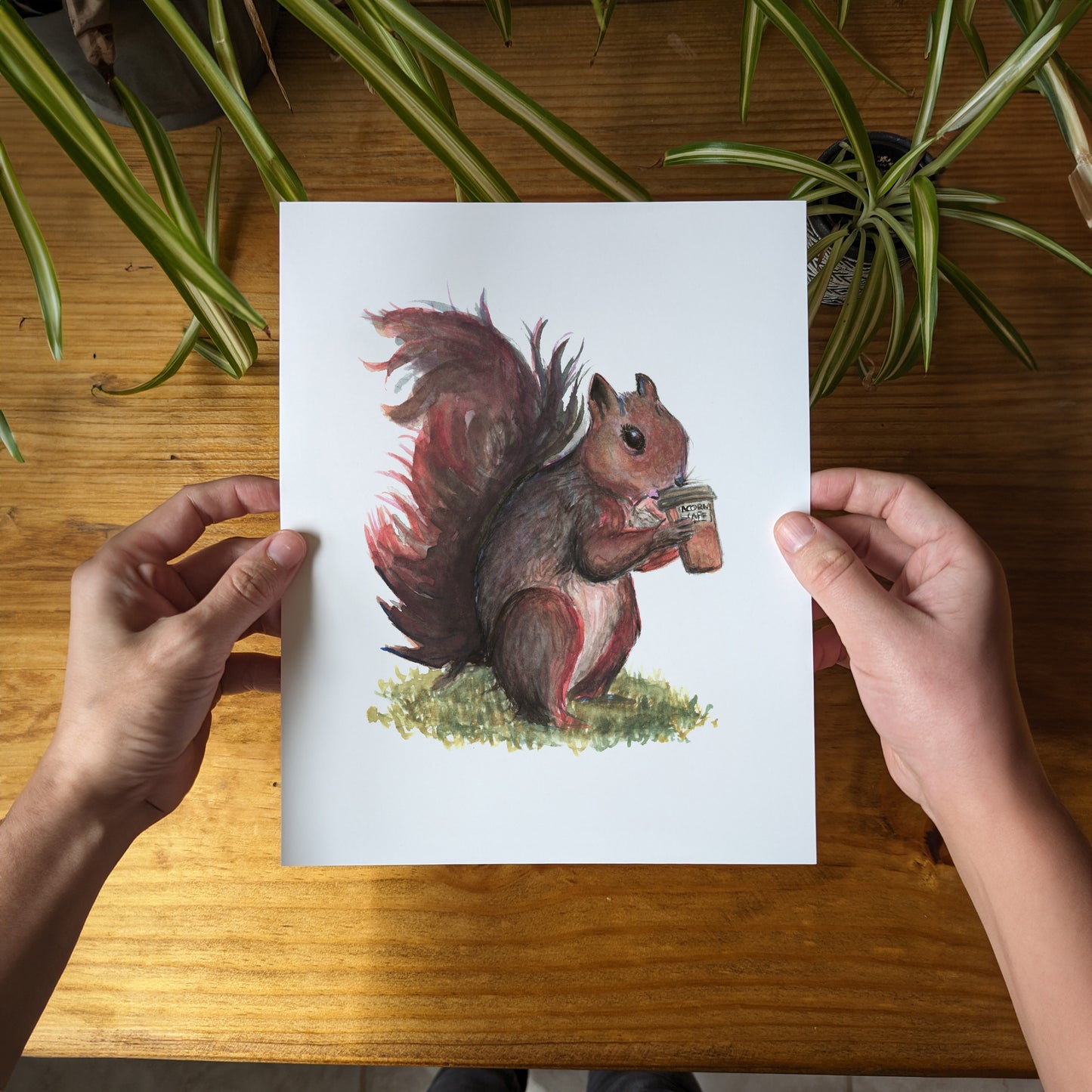 a person holding a card with a picture of a squirrel