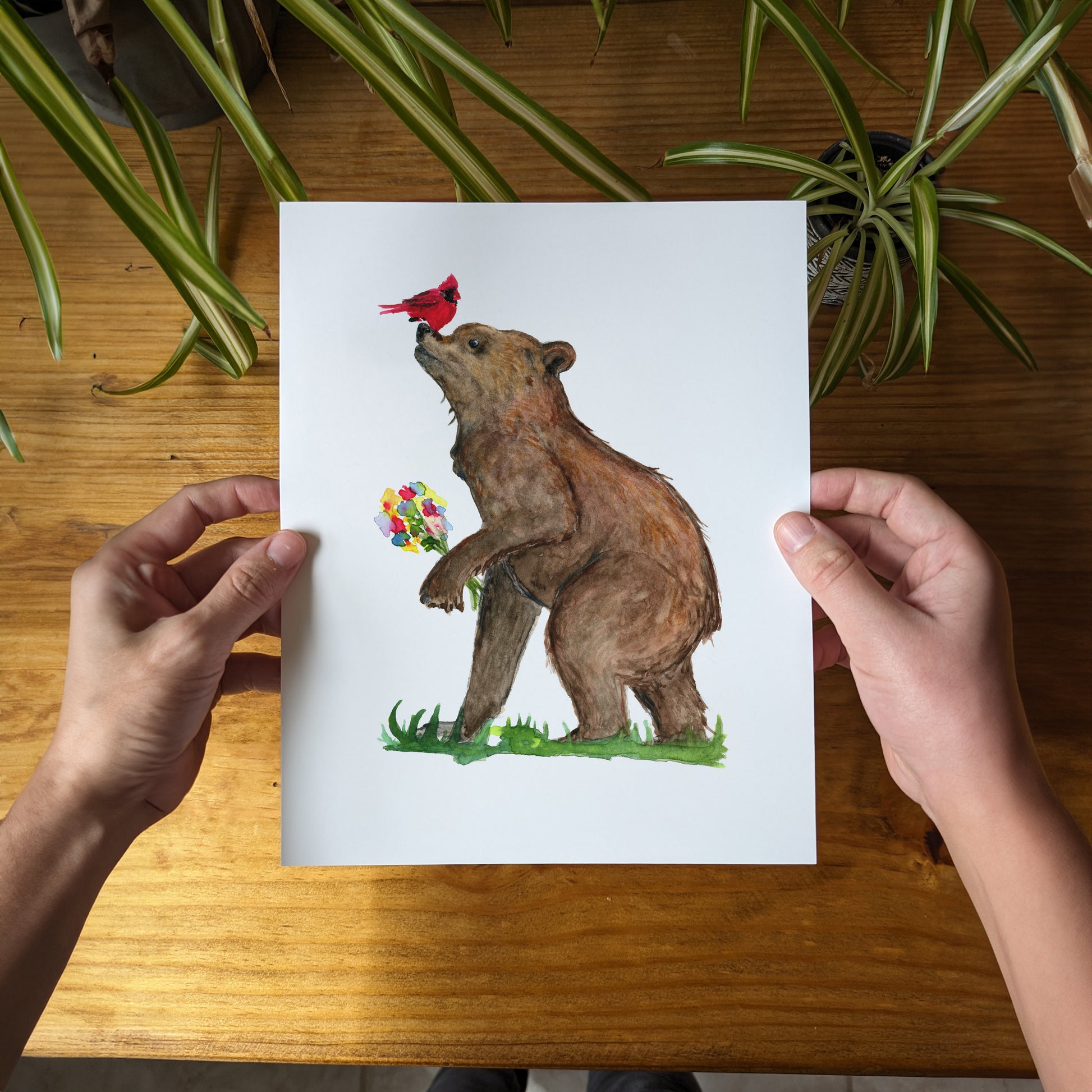 a person holding a card with a bear on it
