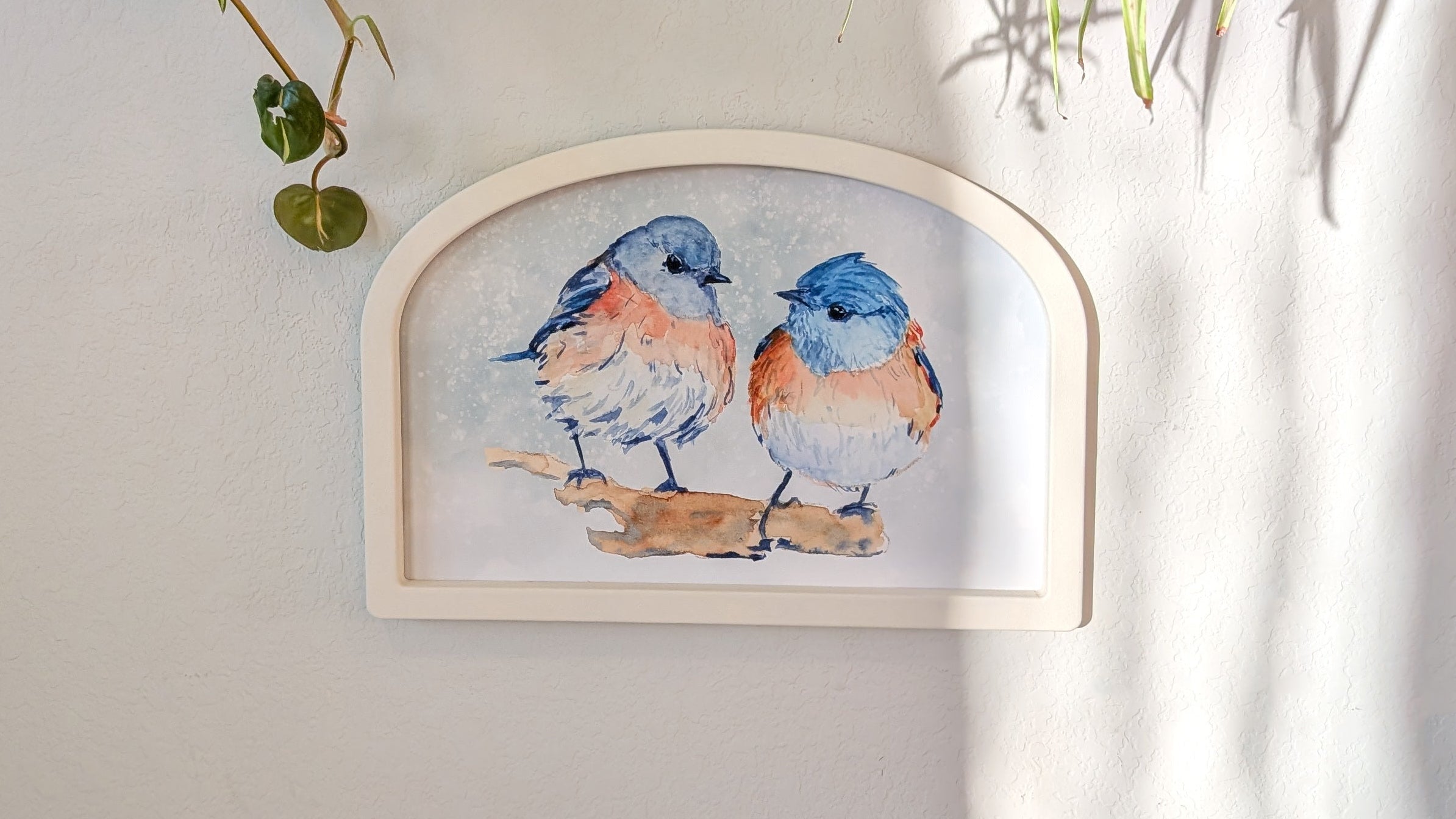 Decorative wall art with two birds on a white wall