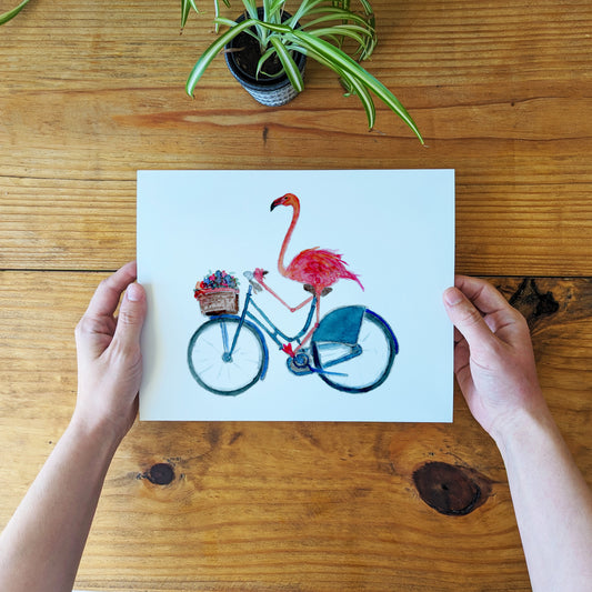 a person holding a card with a flamingo on it