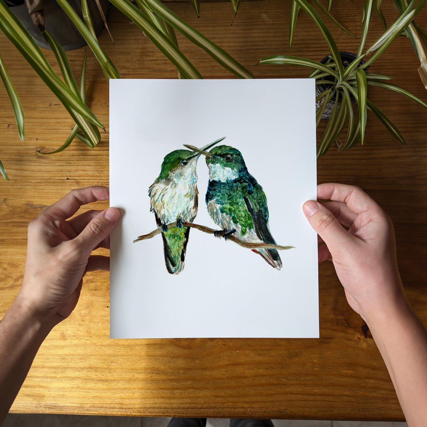 a person holding a card with two birds on it