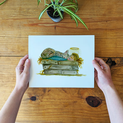 a person holding up a card with a picture of a cat on it